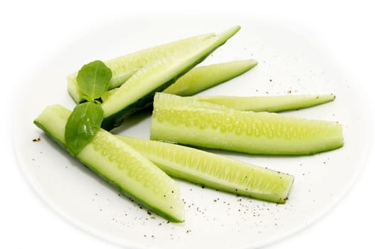 sliced cucumber on a plate on a white background