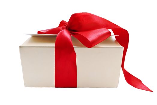 A gold gift box with tied red ribbon trailing onto the ground, isolated on white background.