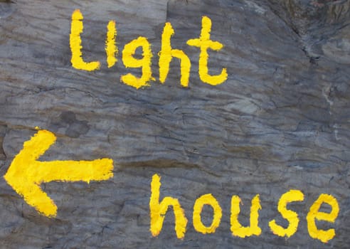 Lighthouse: yellow writing on a wall, with arrow.