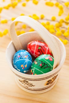 Basket with colored Easter eggs. Vertical view