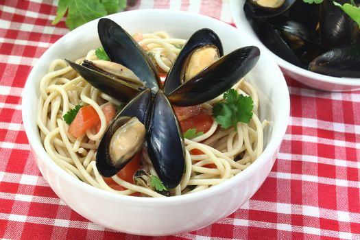 a bowl of spaghetti, mussels and tomato