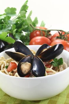 a bowl of spaghetti, mussels and tomato