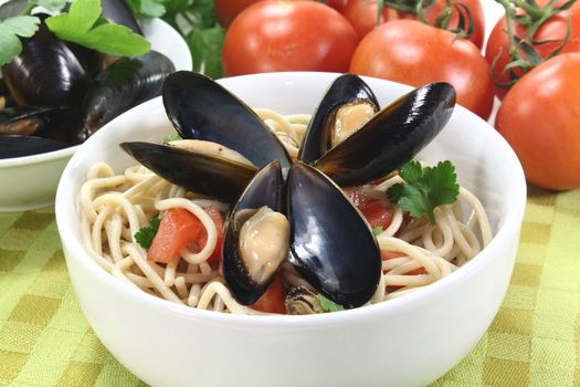 a bowl of spaghetti, mussels and tomato