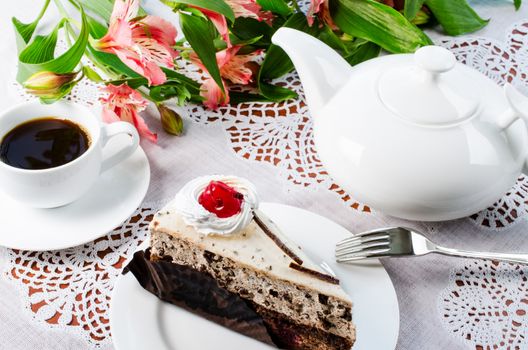 Cherry cake with cup coffee and teapot