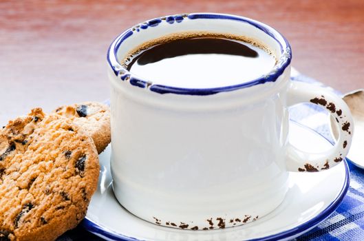 Cup of black cofee with cookie