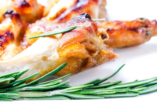 Fried chicken wings with a sprig of rosemary