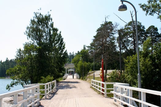 Wooden bridge leading to an island at summertime.