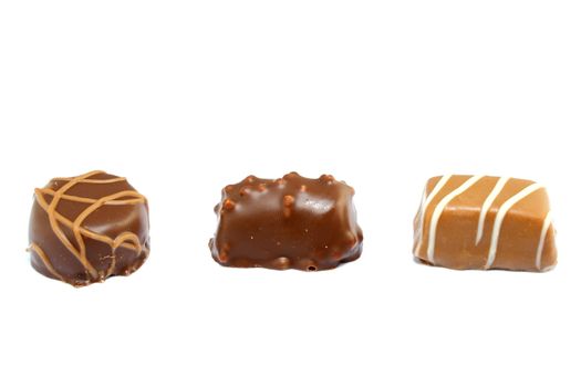 three different types of chocolate candies isolated on white