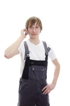 Young warehouse worker calling by mobile. Isolated on white background.