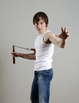 Martial Art. Man with nunchucks