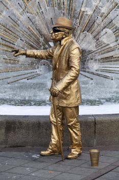 Men dressed in gold gives the appearance in a central square in the city of Oslo, Norway