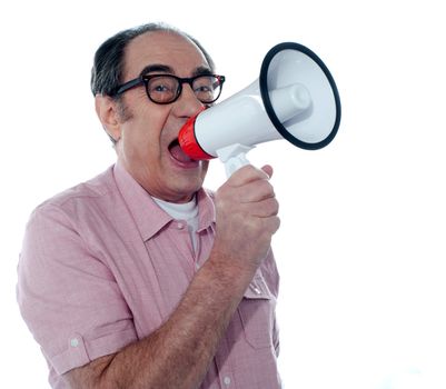 Senior male screaming loudly in a megaphone