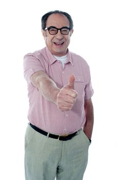 Smiling aged male gesturing thumbs-up, portrait