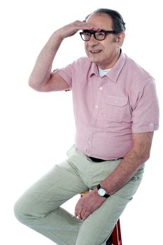 Seated handsome old man looking far away by isolated on white