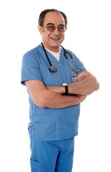 Smiling matured doctor posing with folded arms isolated on white