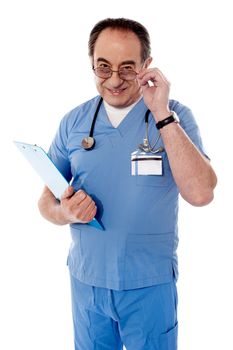 Confident old doctor holding glasses with his head down, also holding reports