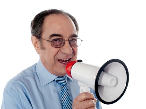 Elderly businessman making an announcement through megaphone