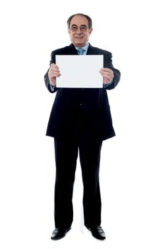 Senior business professional showing blank clipboard to camera isolated on white
