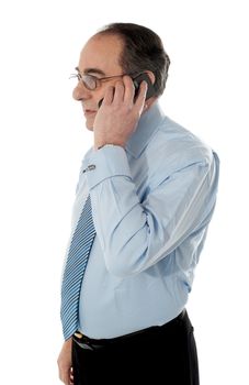 Side view of a senior manager attending phone call isolated on white