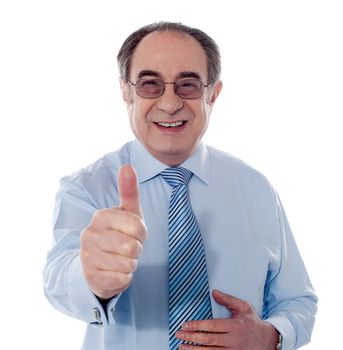 Mature businessman showing thumbs-up gesture isolated on white