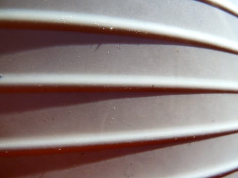 closeup of a white ridged plastic surface