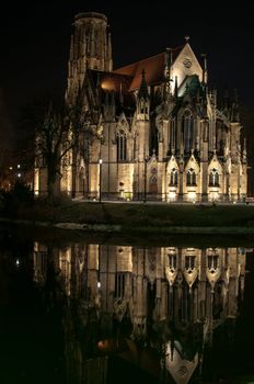 Johannes church in the middle of Feuersee in Stuttgart, Germany at night with great reflection - the church tower was destroyed during world war two. The lake was serving as water resort for the fire brigades many years ago...