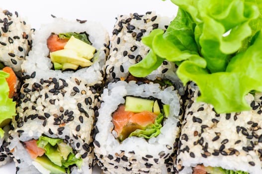 Sushi set with leawes salad on white background