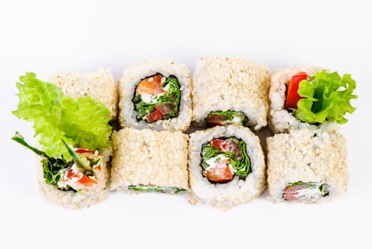 Sushi set with leawes salad and paprika on white background