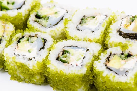 Sushi with fish and green caviar on white background