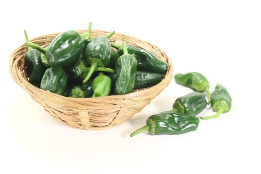 fresh green Pimientos in a bowl on light background