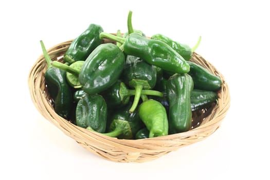 fresh raw Pimientos in a bowl on light background