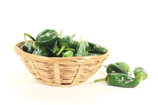 raw green Pimientos in a bowl on light background