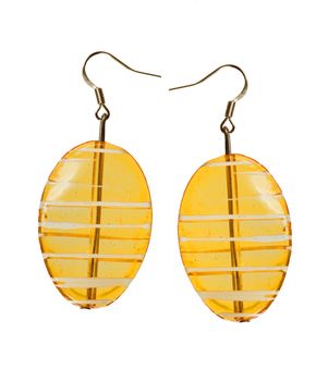 Earrings in yellow glass on a white background. Collage