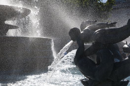 Detail of statue by water fountain in Trafalgar Square, central London, UK