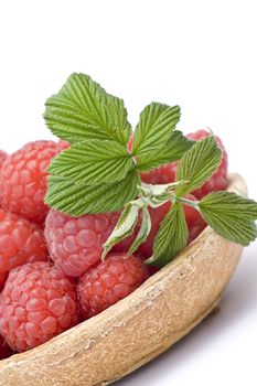 fresh raspberries on a plate, on white background