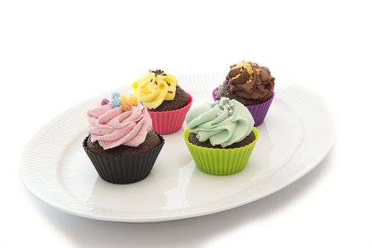 Colourful cupcakes on a classical white dish