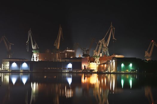 giants in the shipyard in the winter night