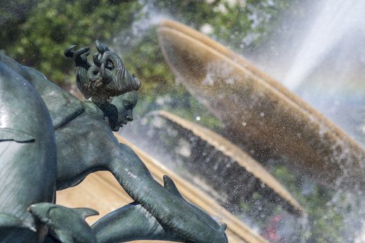 Detail of statue by water fountain in Trafalgar Square, central London, UK