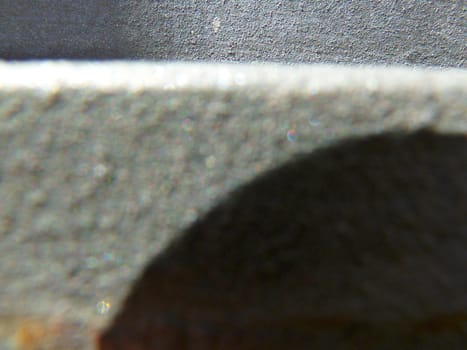 grey metal surface with a dark shadow