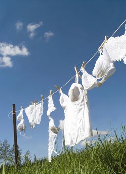 Female underwear on a clothesline towards blue sky