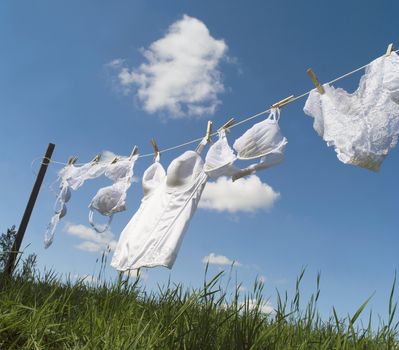 Female underwear on a clothesline towards blue sky