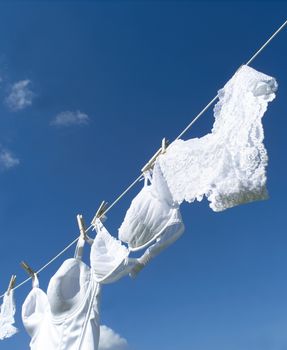 Female underwear on a clothesline towards blue sky