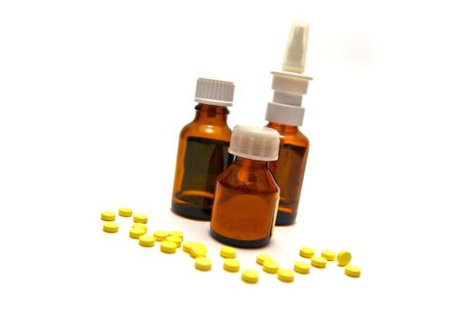 Three bottles of medication and tablets on white background