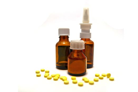 Three bottles of medication and pills on white background