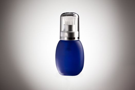 blue glessy bottle with perfume