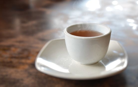 a cup of hot tea on table