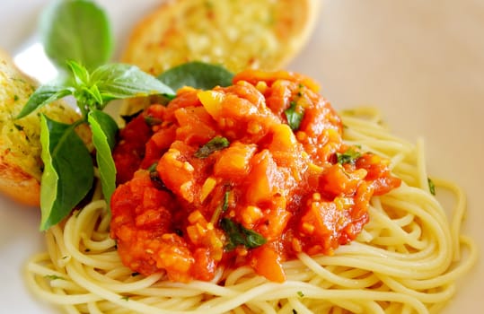 pasta with tomato sauce and meat and garlic bread