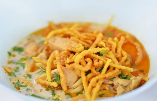 A noodle dish in a yellow curry with chicken. Khao soy a famous northern Thai food.