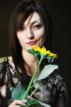 A beautiful woman with sunflower in her hand