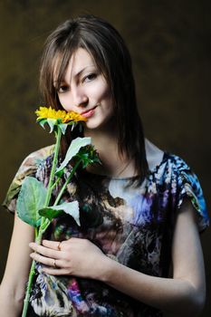 A beautiful woman with a sunflower in her hand